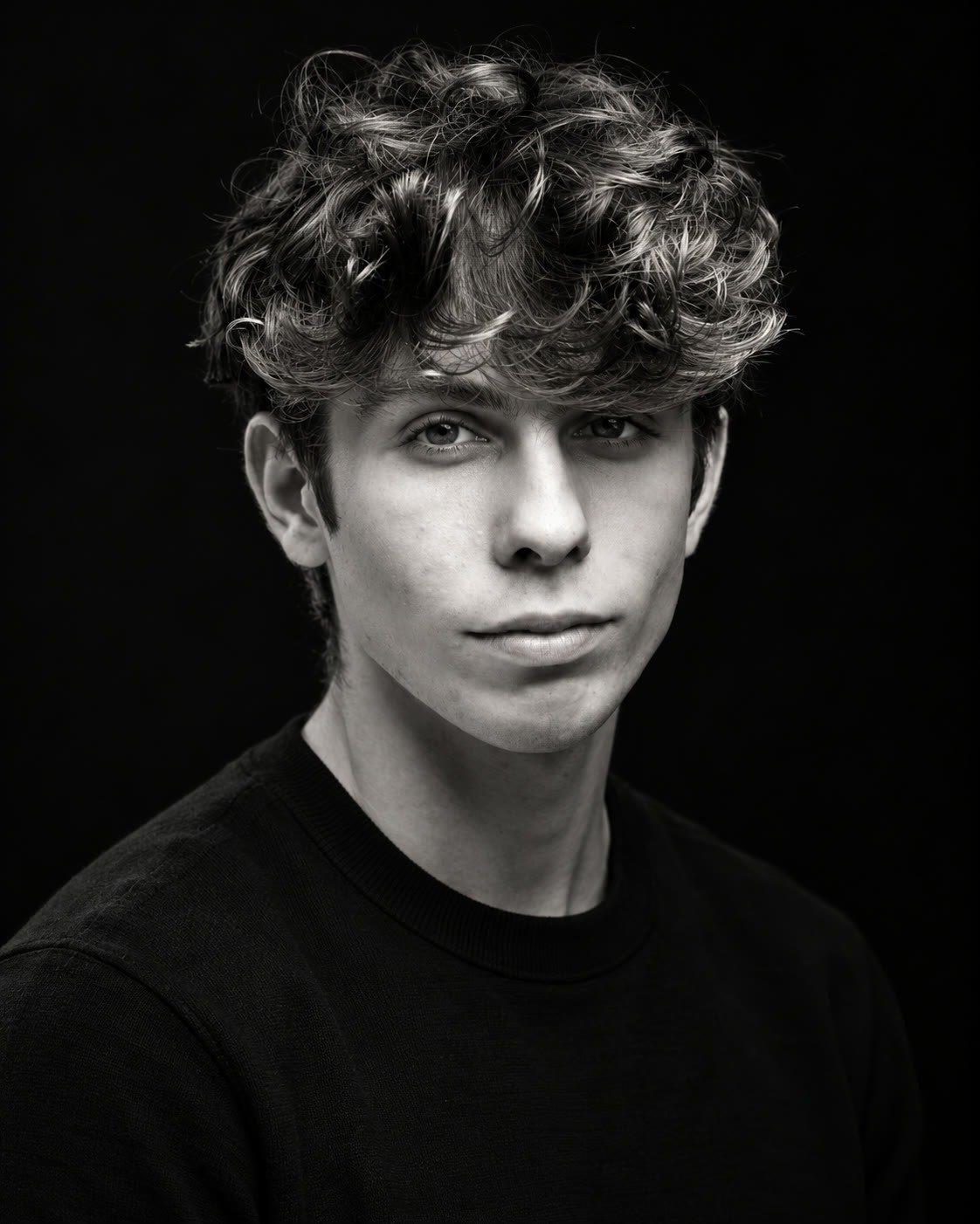Black and white portrait of Gabe Key against a plain dark studio backdrop.