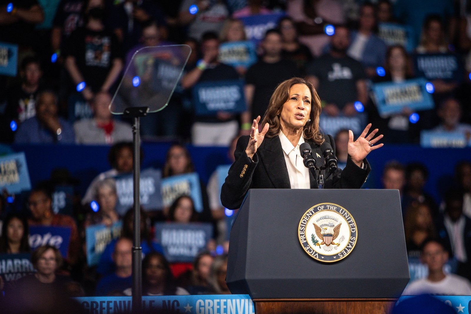 The podium and crowd at a Harris Walz campaign rally in Greenville, North Carolina, 2024.