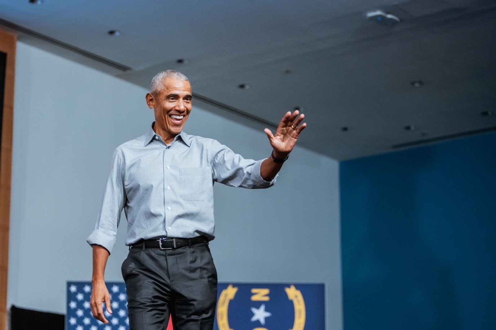A speaker waves to the crowd at a Harris Walz campaign rally in North Carolina, 2024.