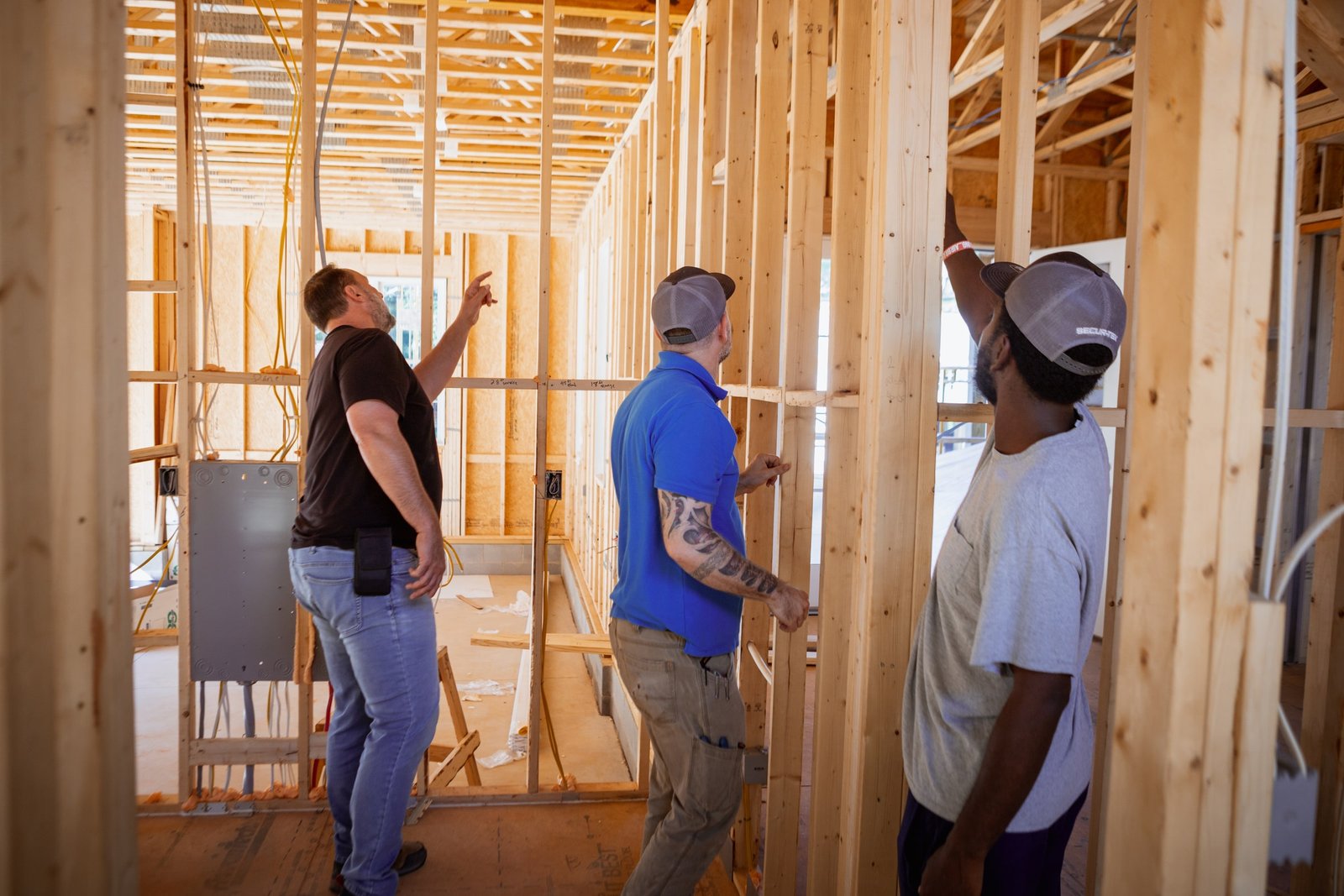 Secur-Tek technicians walk through the framing of a new home during a prewire.